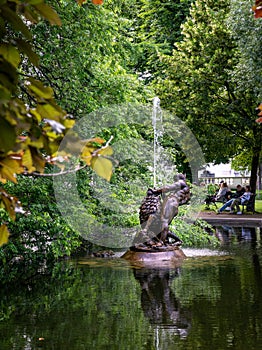 Vertical view of the late Baroque lead sculpture of the Hercules and the Nemean lion fountain in the